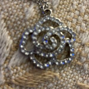 Long silver necklace with rhinestone rose pendant